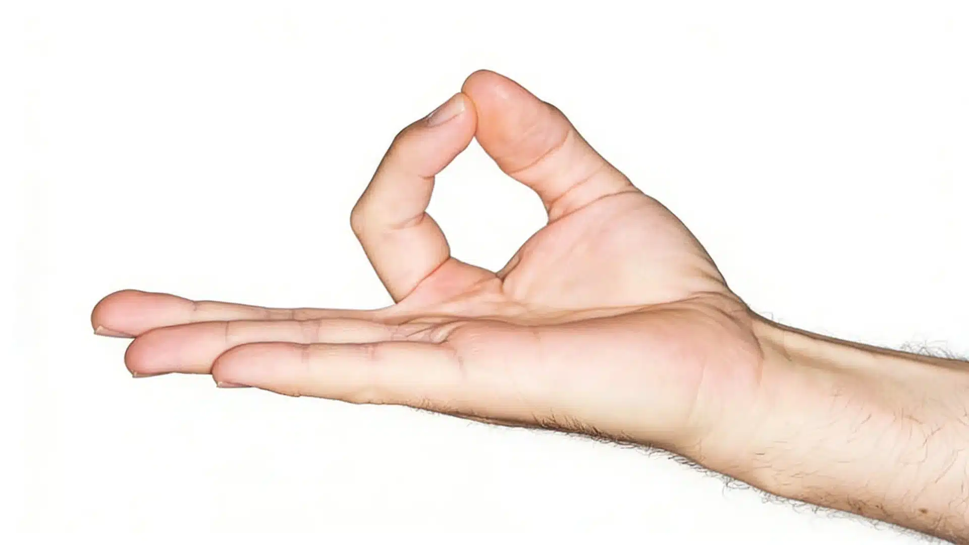 Close-up of a person's hand performing the Gyan mudra gesture, with the tips of the thumb and index finger touching to form a circle.