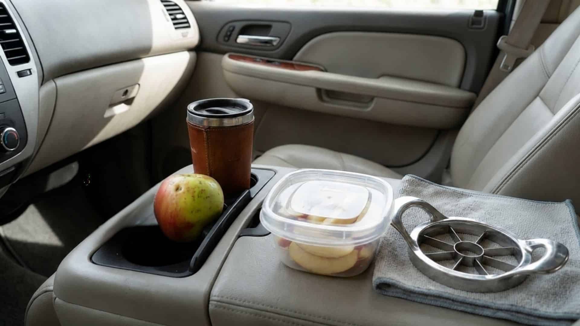 Fresh apple slices and whole apples packed as a healthy road trip snack.
