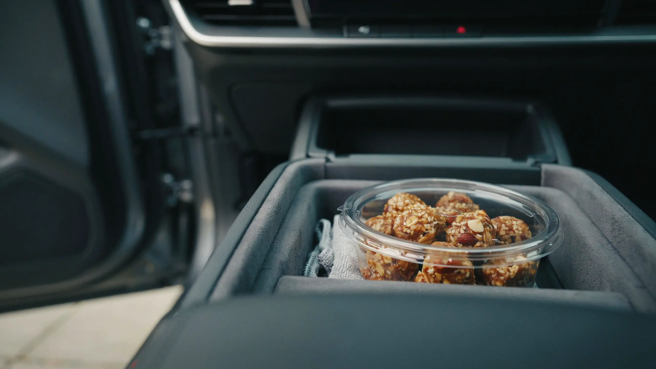 Homemade oat energy bites packed in a container for a healthy road trip snack.