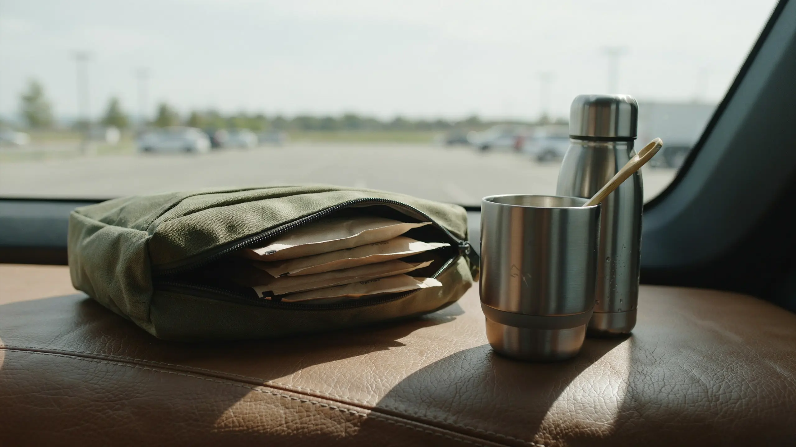 Oatmeal packets with a reusable cup packed for a healthy road trip breakfast.