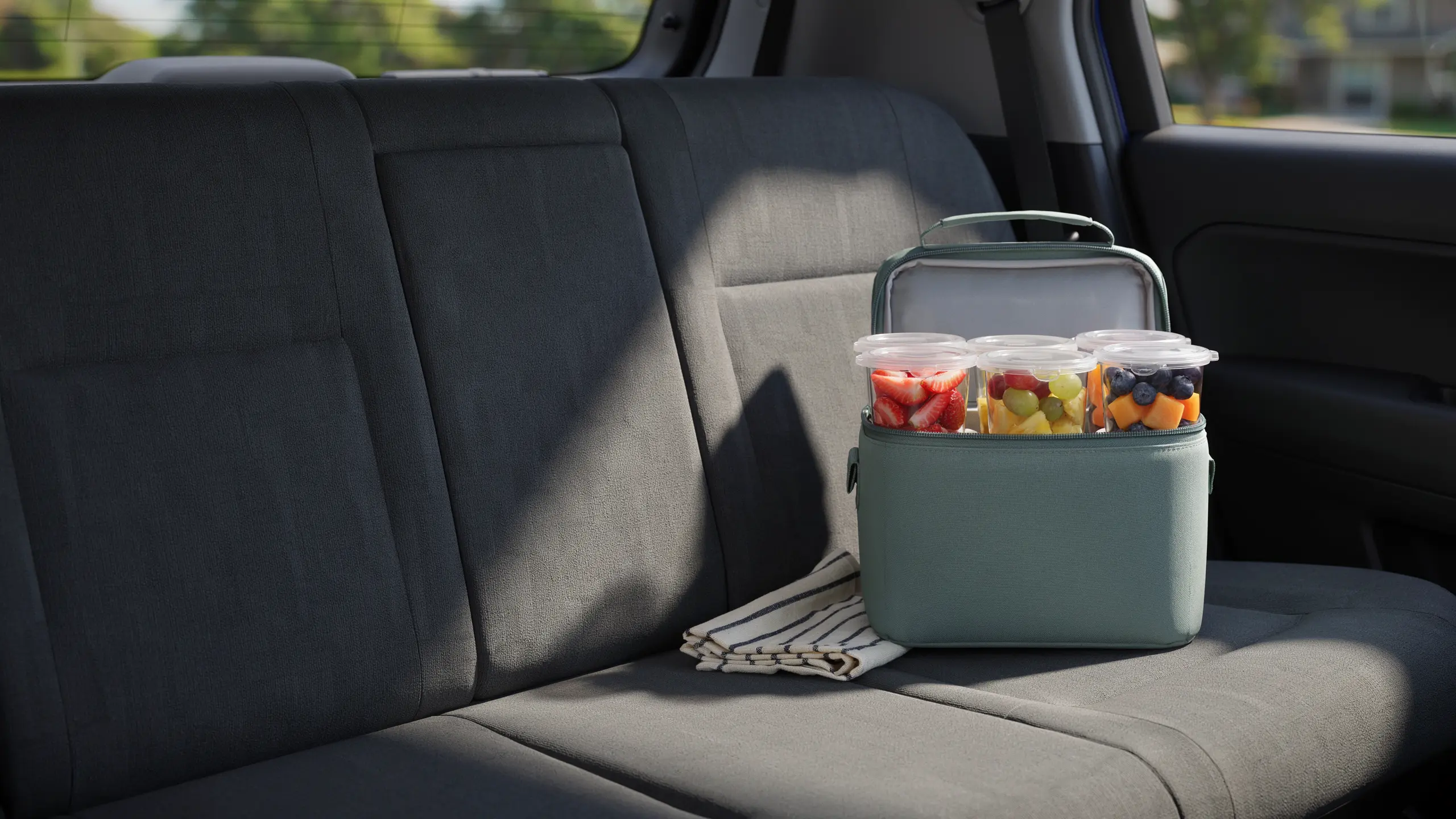 Pre-portioned cut fruit cups packed as a healthy kid-friendly road trip snack.