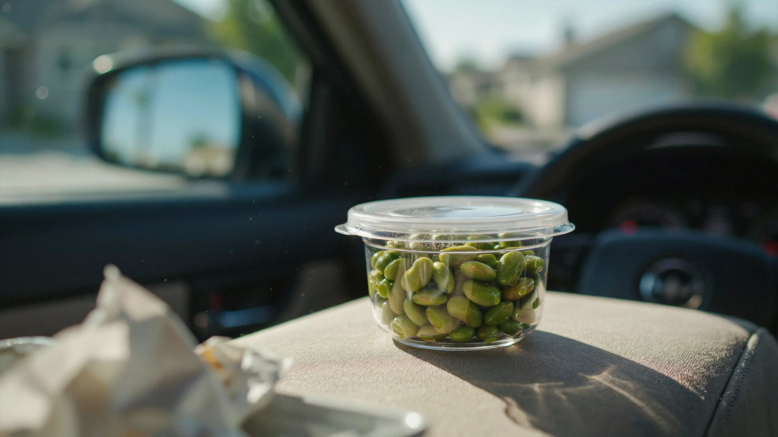 Shelled edamame packed in a container as a plant-based road trip snack.