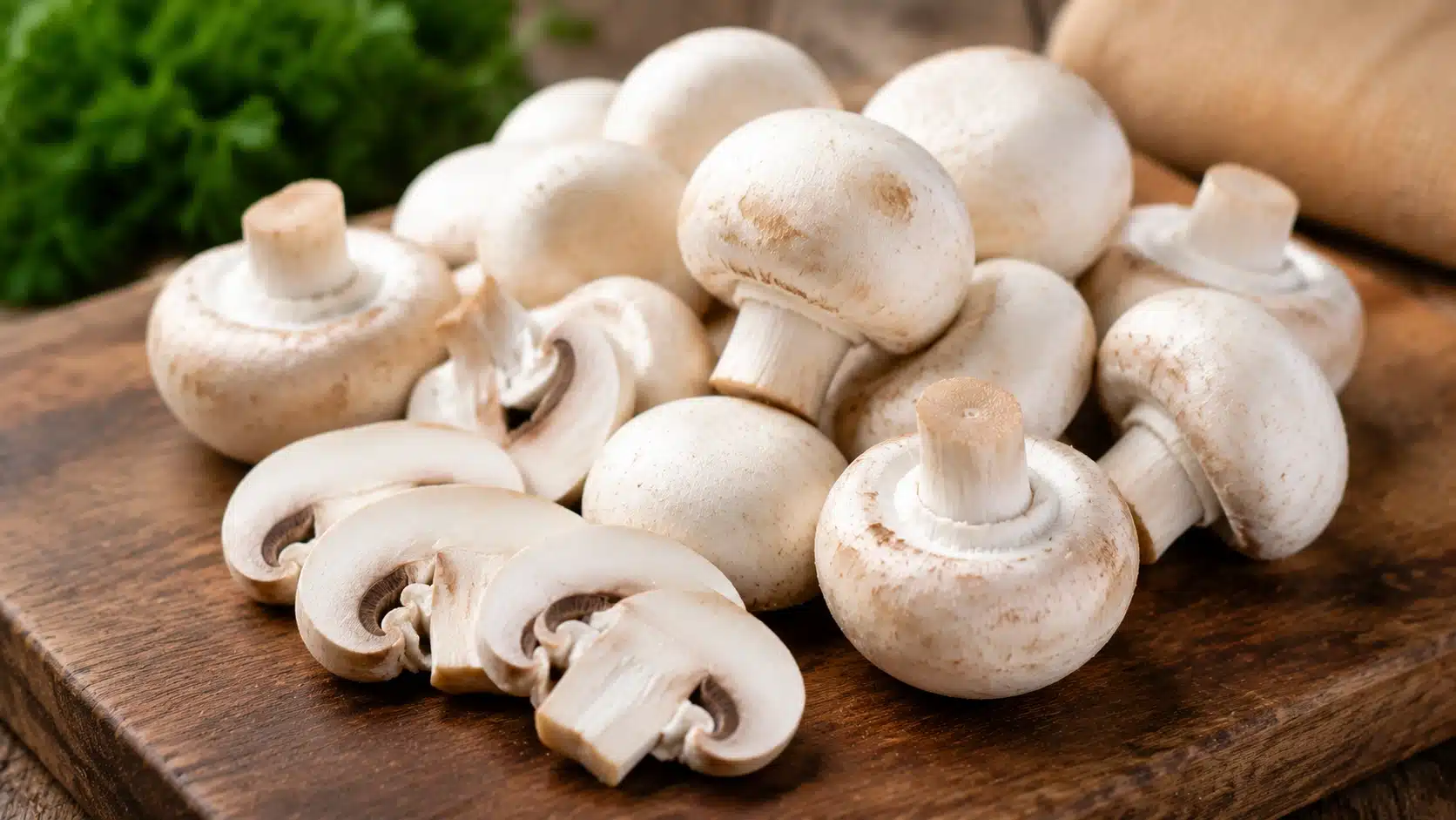 White button mushrooms arranged as a low-carb keto-friendly ingredient for omelets, soups, salads, and stir-fries.