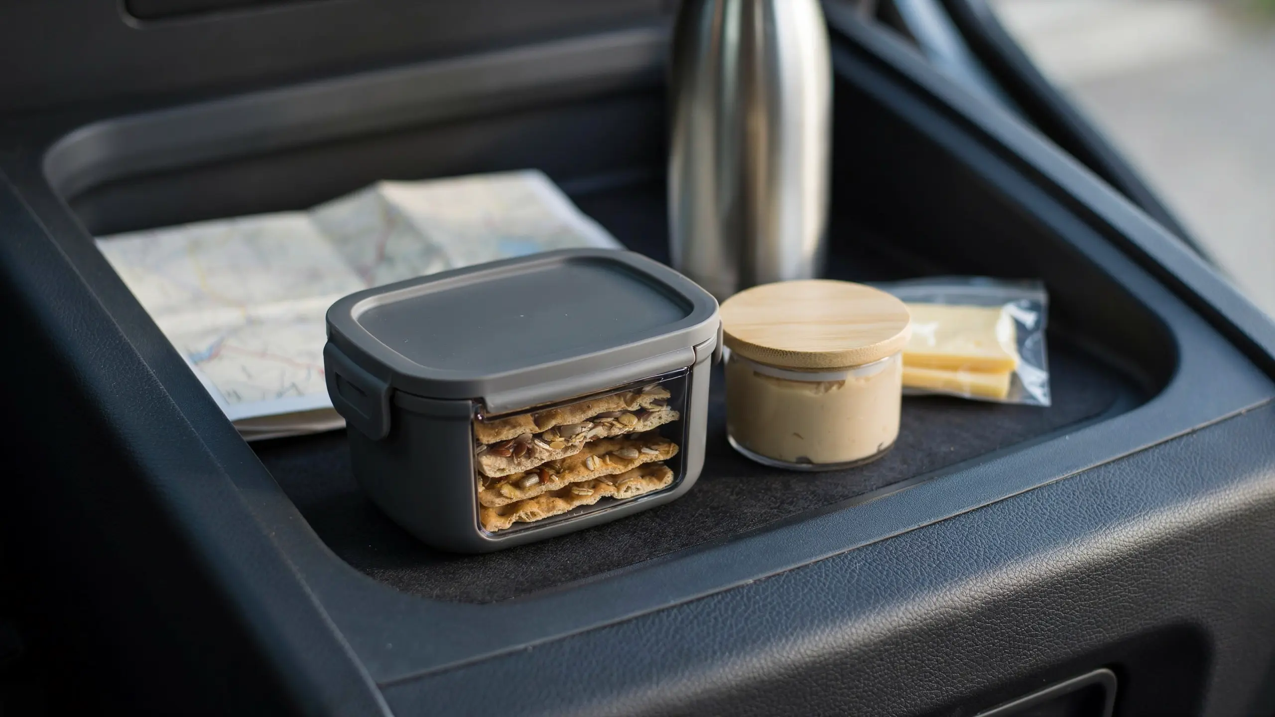 Whole grain crackers stored in a hard container for a road trip snack.