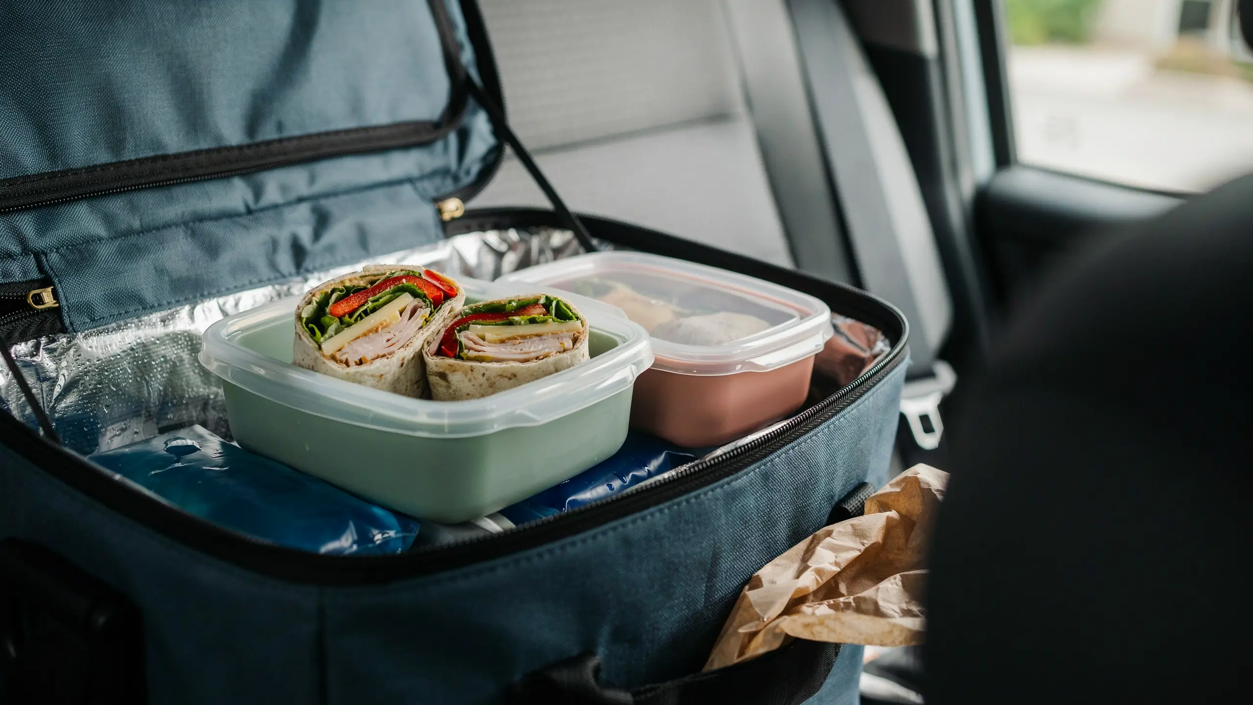 Whole grain wraps with turkey and vegetables packed as a road trip snack.