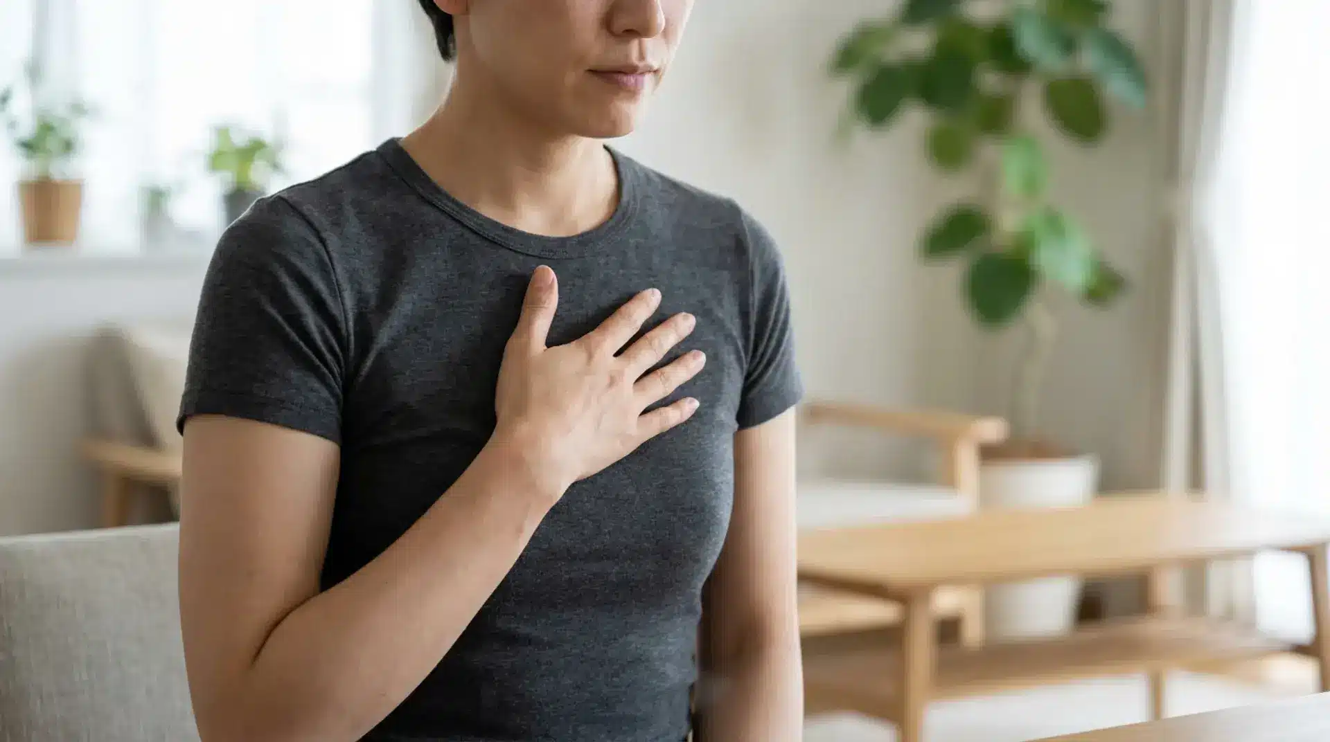 Person gently checking chest discomfort in a realistic health-focused image.